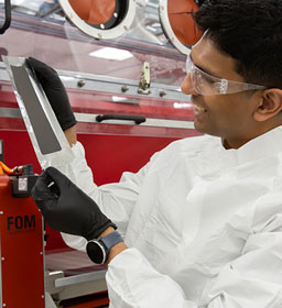 Scientist in lab looking at coating